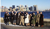 A recent tour group poses for a photo with Manhattan's skyline in the background.